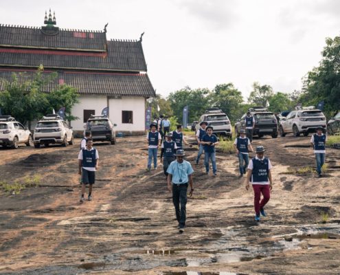 People and vehicles in muddy Laos